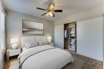 Bedroom with walk-in closet and ceiling fan